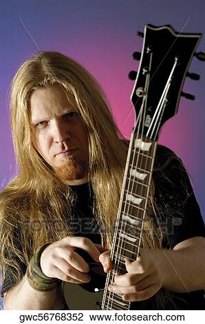 Close-up of a musician holding an electric guitar View Large Photo Image Stock Image - Close-up of a musician holding an electric guitar. Fotosearch