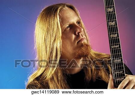 Close-up of a musician holding an electric guitar View Large Photo Image Stock Photo - Close-up of a musician holding an electric guitar. Fotosearch