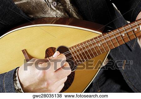 Stock Photo - Close-up of a musician playing the banjo. Fotosearch