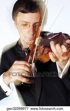 Stock Photo - Close-up of a musician playing the violin. Fotosearch