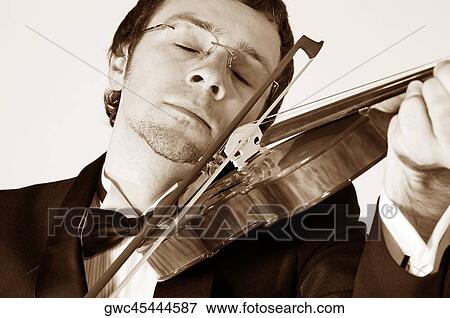 Stock Photo - Close-up of a musician playing the violin. Fotosearch
