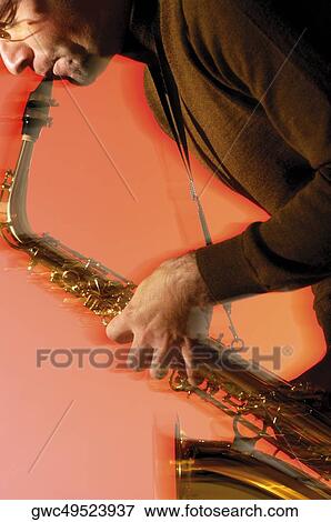 Close-up of a musician playing the saxophone View Large Photo Image Stock Photo - Close-up of a musician playing the saxophone. Fotosearch