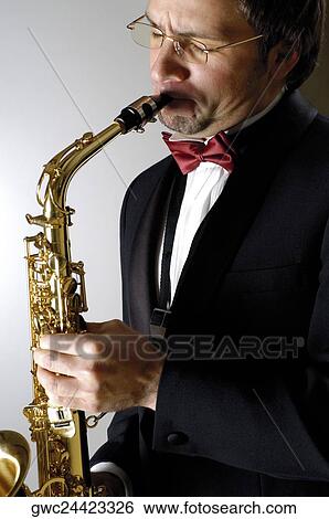 Close-up of a musician playing the saxophone View Large Photo Image Stock Photograph - Close-up of a musician playing the saxophone. Fotosearch
