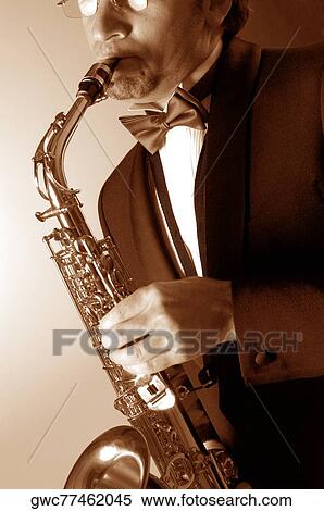 Close-up of a musician playing the saxophone View Large Photo Image Stock Photography - Close-up of a musician playing the saxophone. Fotosearch
