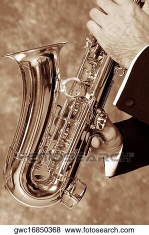 Stock Photo - Close-up of a musician's hand playing the saxophone. Fotosearch