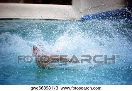 Close-up of a person splashing water in a swimming pool View Large Photo Image Stock Image - Close-up of a person splashing water in a swimming pool. Fotosearch