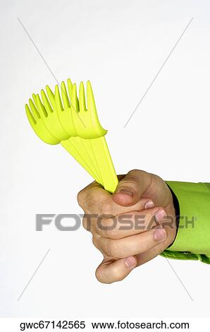 Close-up of a person's hand holding four plastic forks View Large Photo Image Stock Photography - Close-up of a person's hand holding four plastic forks. Fotosearch