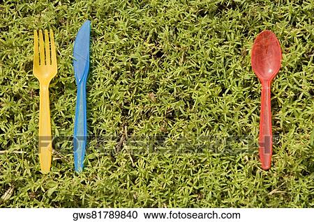 Close-up of a plastic spoon with a plastic knife and a plastic fork lying on the grass View Large Photo Image Stock Image - Close-up of a plastic spoon with a plastic knife and a plastic fork lying on the grass. Fotosearch