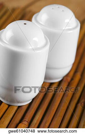 Stock Photo - Close-up of a salt shaker and a pepper shaker. Fotosearch