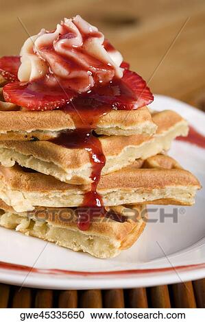 Stock Image - Close-up of a strawberry waffle in a plate. Fotosearch