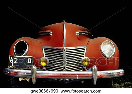 Stock Image - Close-up of a vintage car with a broken headlight. Fotosearch