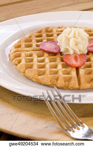 Close-up of a waffle on a plate View Large Photo Image Picture - Close-up of a waffle on a plate. Fotosearch
