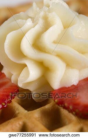 Close-up of a waffle with strawberry slice and whipped cream on it View Large Photo Image Stock Image - Close-up of a waffle with strawberry slice and whipped cream on it. Fotosearch