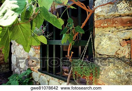 Stock Image - Close-up of a window on a stone wall. Fotosearch