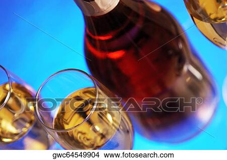 Close-up of a wine bottle with champagne in three champagne flutes View Large Photo Image Picture - Close-up of a wine bottle with champagne in three champagne flutes. Fotosearch