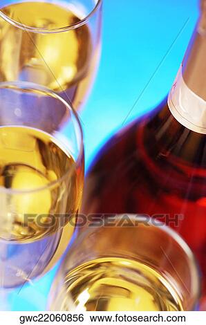 Close-up of a wine bottle with champagne in three champagne flutes View Large Photo Image Stock Photograph - Close-up of a wine bottle with champagne in three champagne flutes. Fotosearch