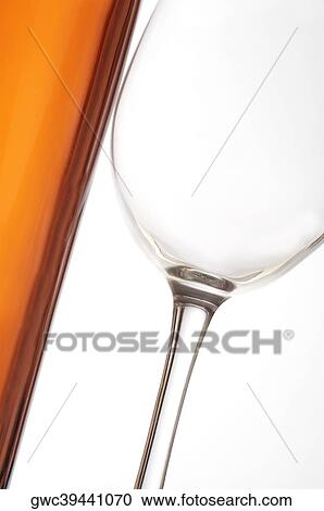 Stock Image - Close-up of a wineglass and a wine bottle. Fotosearch