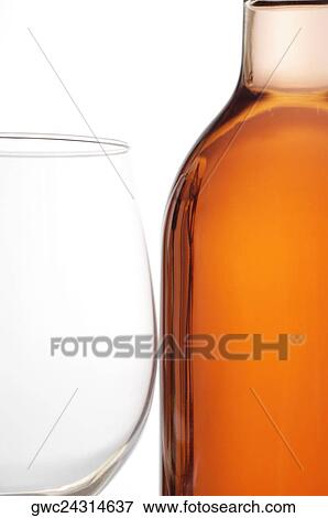 Stock Photo - Close-up of a wineglass and a wine bottle. Fotosearch