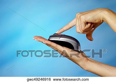 Close-up of a woman's finger pressing computer mouse on her hand View Large Photo Image Stock Photograph - Close-up of a woman's finger pressing computer mouse on her hand. Fotosearch