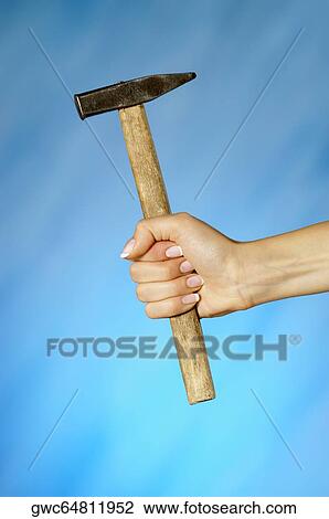 Close-up of a woman's hand holding a hammer View Large Photo Image Stock Image - Close-up of a woman's hand holding a hammer. Fotosearch