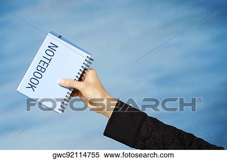 Close-up of a woman's hand holding a spiral notebook View Large Photo Image Stock Photography - Close-up of a woman's hand holding a spiral notebook. Fotosearch