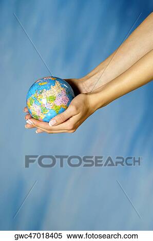Close-up of a woman's hands holding a globe View Large Photo Image Stock Photography - Close-up of a woman's hands holding a globe. Fotosearch