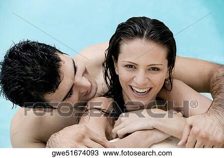 Close-up of a young couple in a swimming pool View Large Photo Image Stock Image - Close-up of a young couple in a swimming pool. Fotosearch