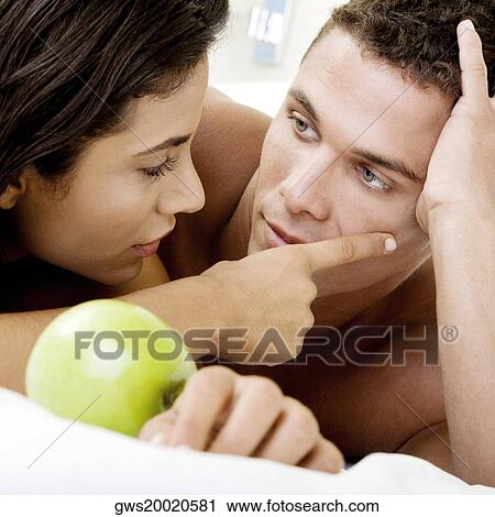 Close-up of a young couple looking at each other View Large Photo Image Stock Image - Close-up of a young couple looking at each other. Fotosearch