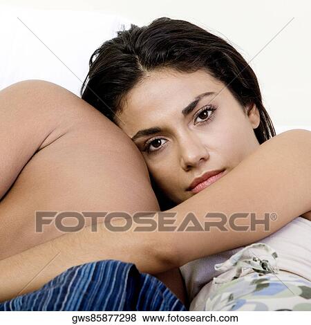Close-up of a young couple lying on a bed View Large Photo Image Stock Photo - Close-up of a young couple lying on a bed. Fotosearch