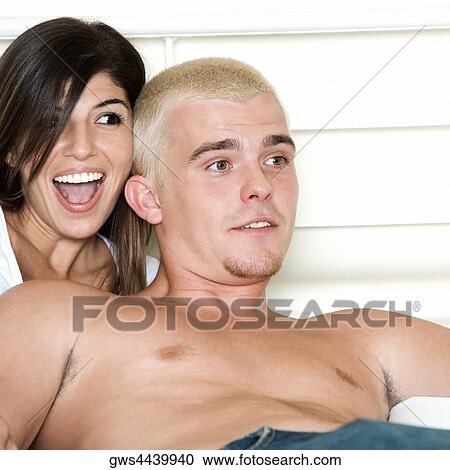 Close-up of a young couple smiling View Large Photo Image Stock Image - Close-up of a young couple smiling. Fotosearch
