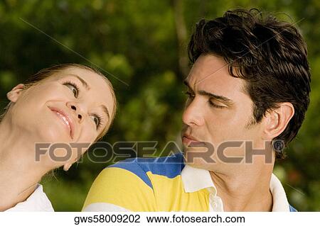 Close-up of a young man and a teenage girl looking at each other View Large Photo Image Stock Image - Close-up of a young man and a teenage girl looking at each other. Fotosearch