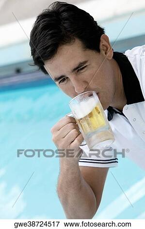 Close-up of a young man drinking beer View Large Photo Image Stock Photo - Close-up of a young man drinking beer. Fotosearch