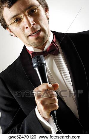 Close-up of a young man holding a microphone View Large Photo Image Stock Image - Close-up of a young man holding a microphone. Fotosearch