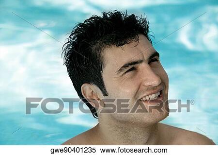 Close-up of a young man in a swimming pool View Large Photo Image Stock Photography - Close-up of a young man in a swimming pool. Fotosearch