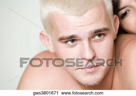 Close-up of a young man looking away View Large Photo Image Stock Image - Close-up of a young man looking away. Fotosearch