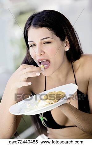 Close-up of a young woman having a meal View Large Photo Image Stock Photography - Close-up of a young woman having a meal. Fotosearch