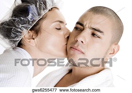 Stock Photo - Close-up of a young woman kissing a young man. Fotosearch