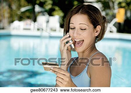 Close-up of a young woman laughing on a mobile phone View Large Photo Image Stock Image - Close-up of a young woman laughing on a mobile phone. Fotosearch