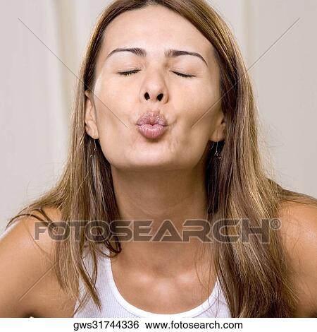 Close-up of a young woman puckering her lips View Large Photo Image Stock Photograph - Close-up of a young woman puckering her lips. Fotosearch