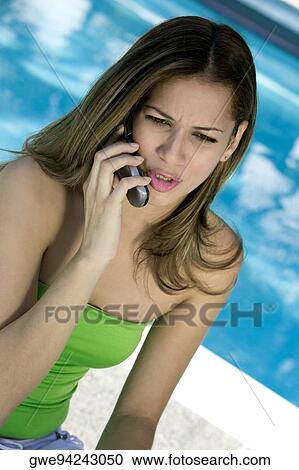 Stock Image - Close-up of a young woman talking on a mobile phone. Fotosearch