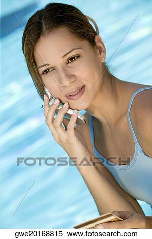 Close-up of a young woman talking on a mobile phone View Large Photo Image Stock Photography - Close-up of a young woman talking on a mobile phone. Fotosearch