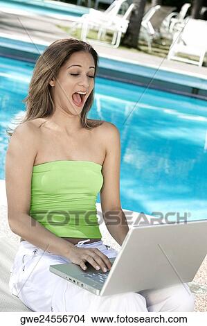 Close-up of a young woman using a laptop View Large Photo Image Picture - Close-up of a young woman using a laptop. Fotosearch