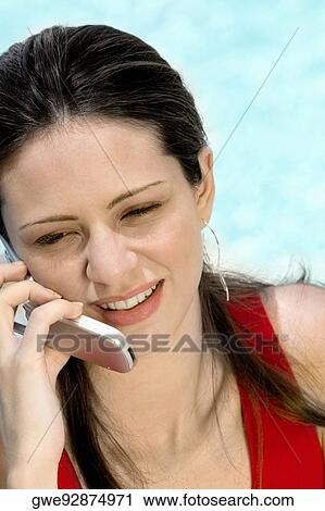Close-up of a young woman using a mobile phone View Large Photo Image Stock Image - Close-up of a young woman using a mobile phone. Fotosearch