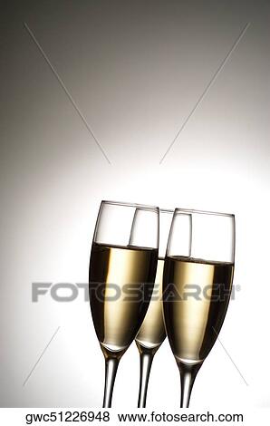 Close-up of champagne in three champagne flutes View Large Photo Image Stock Photo - Close-up of champagne in three champagne flutes. Fotosearch