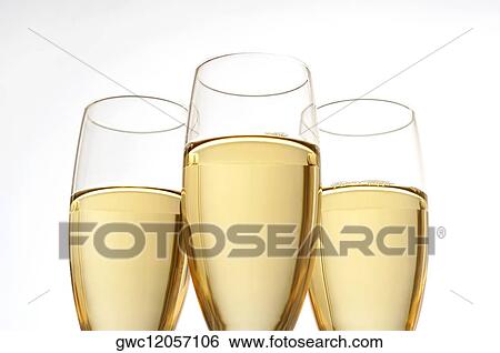 Close-up of champagne in three champagne flutes View Large Photo Image Stock Photograph - Close-up of champagne in three champagne flutes. Fotosearch