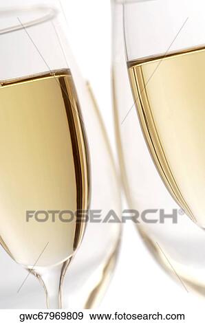 Close-up of champagne in two champagne flutes View Large Photo Image Stock Photo - Close-up of champagne in two champagne flutes. Fotosearch