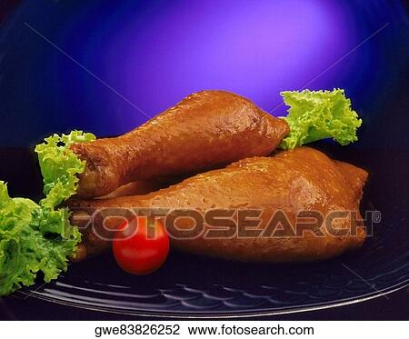 Close-up of chicken drumsticks with a tomato View Large Photo Image Stock Image - Close-up of chicken drumsticks with a tomato. Fotosearch