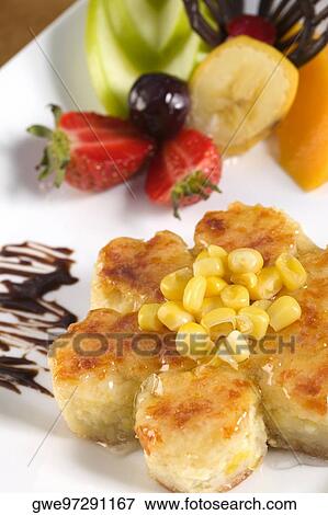 Close-up of corn cakes and fruits in a plate View Large Photo Image Stock Photo - Close-up of corn cakes and fruits in a plate. Fotosearch