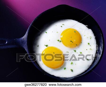 Close-up of eggs frying in a pan View Large Photo Image Stock Image - Close-up of eggs frying in a pan. Fotosearch