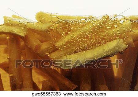Close-up of French fries frying in oil View Large Photo Image Stock Image - Close-up of French fries frying in oil. Fotosearch